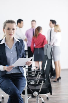 business woman standing with her staff in background photo