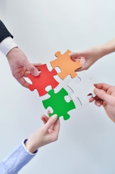 Group of business people assembling jigsaw puzzle photo