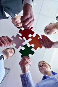 Group of business people assembling jigsaw puzzle photo