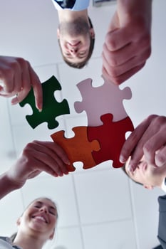 Group of business people assembling jigsaw puzzle photo