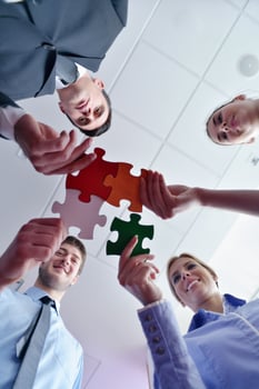 Group of business people assembling jigsaw puzzle photo