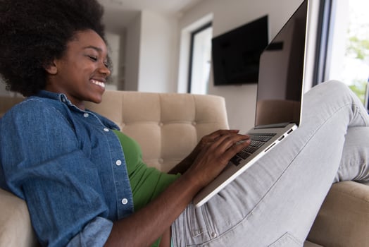 African American women at home in the chair using a laptop photo