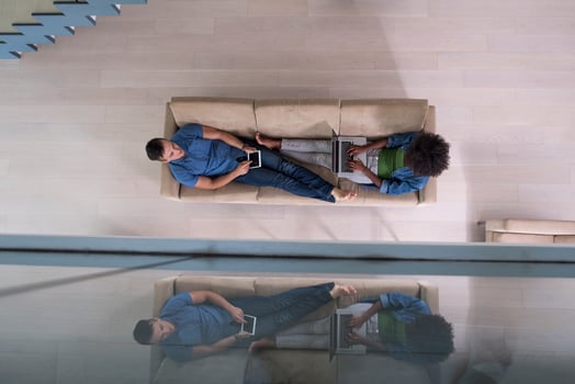 young multiethnic couple relaxes in the living room top view photo