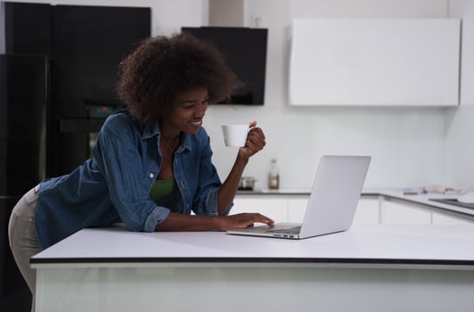 smiling black woman in modern kitchen photo