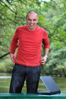 young businessman working on laptop outdoor photo