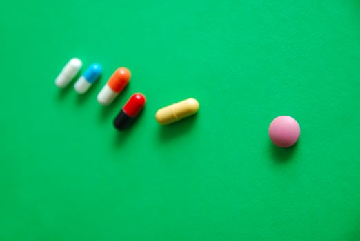 pills on green background photo