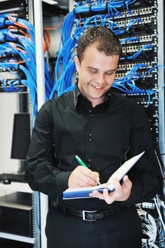 young it engeneer in datacenter server room photo