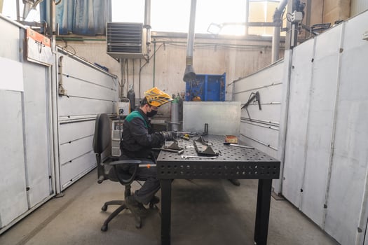 Metal industry worker working in factory, wearing protective face mask during coronavirus or covid19 pandemic. photo