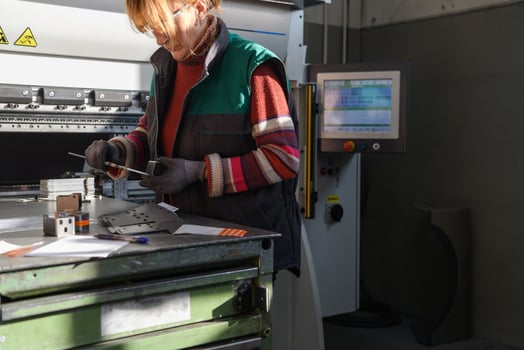 woman working in a modern factory and preparing materia for a CNC machine. photo