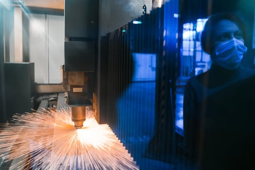 Turkey, 2022 - Sparks fly out machine head for metal processing laser metal on metallurgical plant background. Manufacturing finished parts for automotive production concept photo