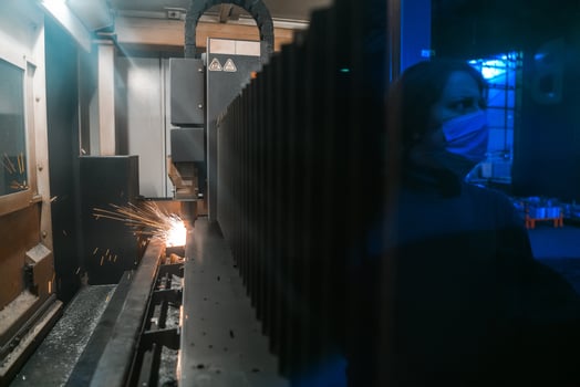 Turkey, 2022 - Sparks fly out machine head for metal processing laser metal on metallurgical plant background. Manufacturing finished parts for automotive production concept photo