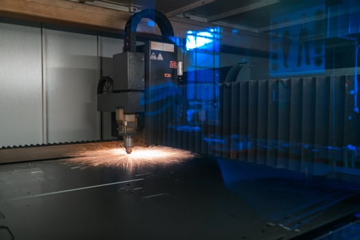 Sparks fly out machine head for metal processing laser metal on metallurgical plant background. Manufacturing finished parts for automotive production concept photo