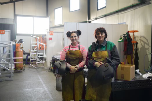 portrait of two welders holding welding masks in their hands and preparing for hard work in a factory photo