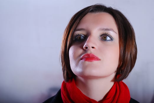 Portrait of a young woman wearing red scarf photo