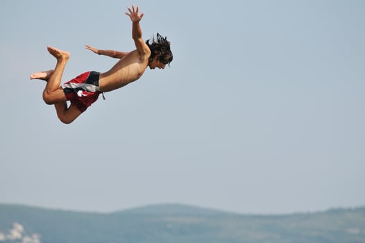 boy jump sea photo