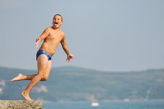 boy jump sea photo