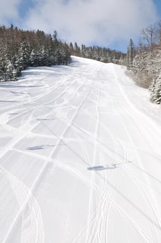 tracks on ski slopes at beautiful sunny  winter day photo