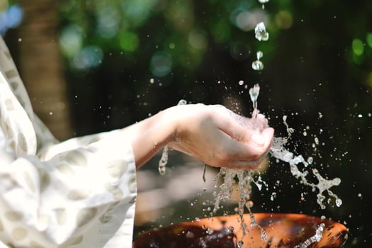 splashing fresh water on woman hands photo