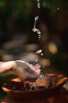 splashing fresh water on woman hands photo