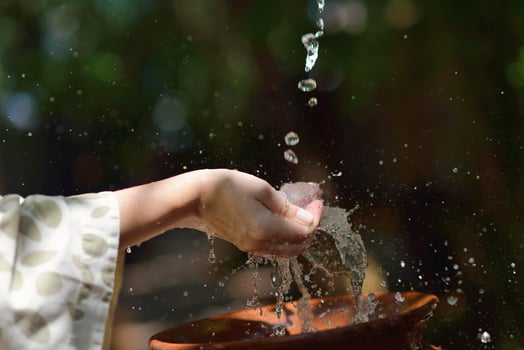 splashing fresh water on woman hands photo