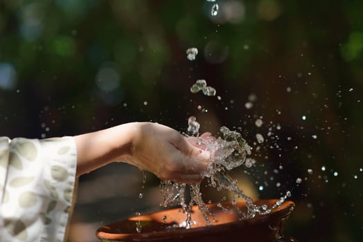 splashing fresh water on woman hands photo