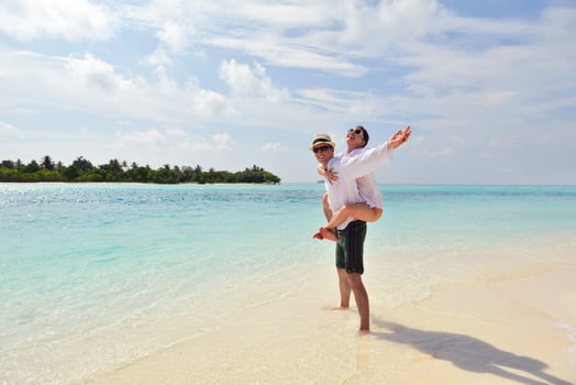 happy young couple have fun on beach photo