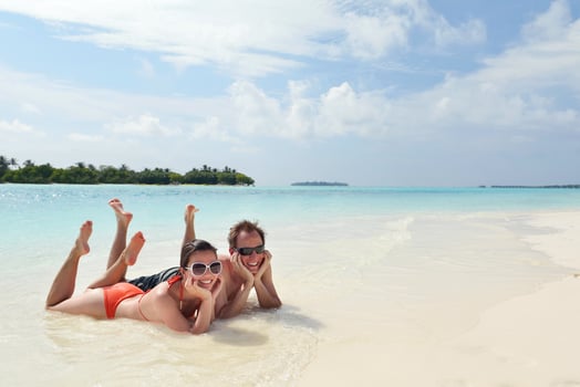 happy young couple have fun on beach photo
