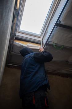 roofer man installing thermal insulation layer photo