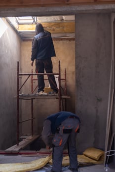 roofer man installing thermal insulation layer photo