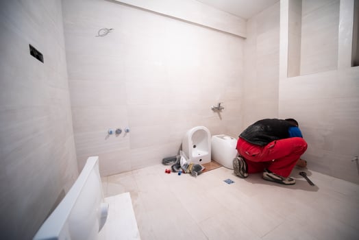 professional plumber working in a bathroom photo