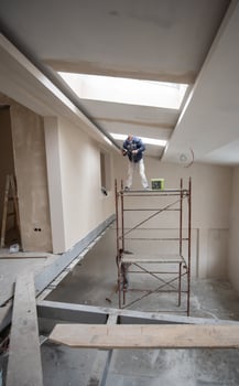 construction worker plastering on gypsum ceiling photo