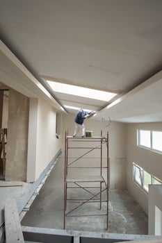 construction worker plastering on gypsum ceiling photo