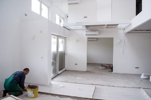 worker installing the ceramic wood effect tiles on the floor photo