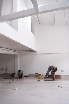 worker installing the ceramic wood effect tiles on the floor photo