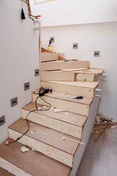 work in progress on stylish interior with wooden stairs photo