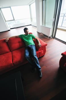 man relaxing on sofa photo