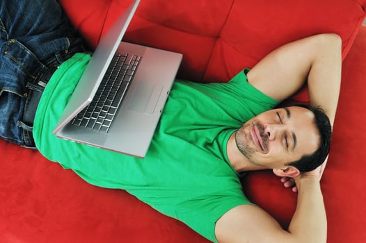 man relaxing on sofa photo