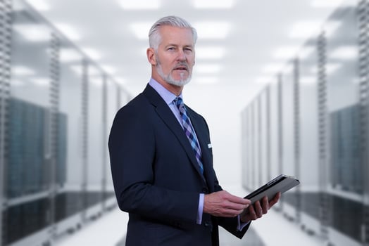 Senior businessman in server room photo
