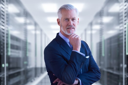 Senior businessman in server room photo