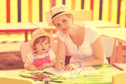 mom and little daughter drawing a colorful pictures photo