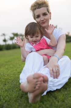 mother and little daughter playing at backyard photo