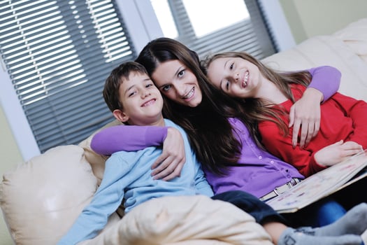 young mom play with their kids at home and reading book photo