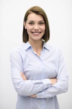 Portrati shot of beautiful blond businesswoman standing with arms crossed at isolated white background. photo