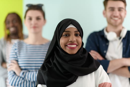 group of diverse teenagers posing in a studio, determined teenagers in diverse clothing. photo