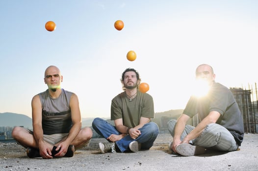 three man outdoor play with orange fruit photo