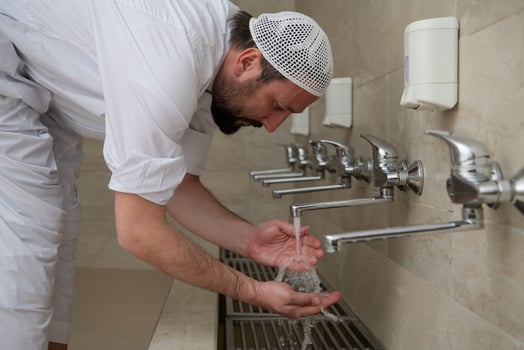 A Muslim takes ablution for prayer. Islamic religious rite photo
