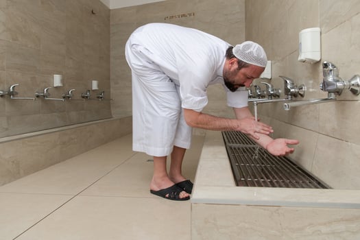 A Muslim takes ablution for prayer. Islamic religious rite photo
