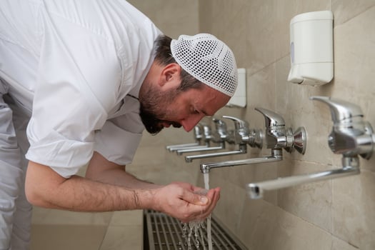 A Muslim takes ablution for prayer. Islamic religious rite photo