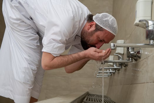 A Muslim takes ablution for prayer. Islamic religious rite photo