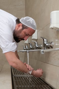 A Muslim takes ablution for prayer. Islamic religious rite photo